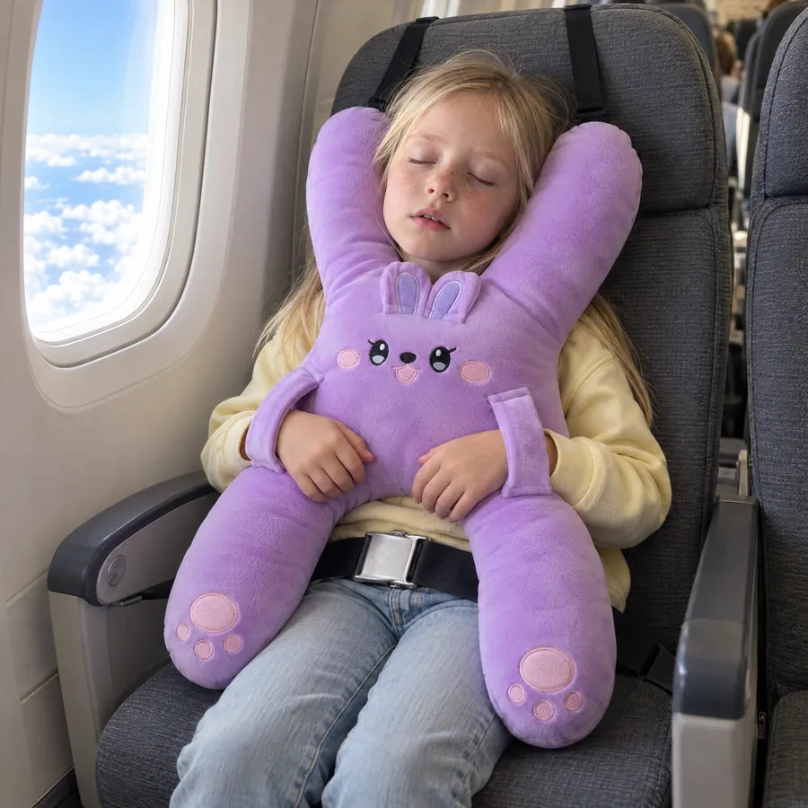 A girl asleep on a plane with Nina the Bunny