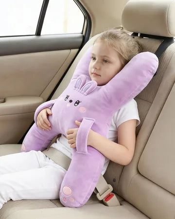 A girl on the back seat hugging Nina the Bunny, seat belt on