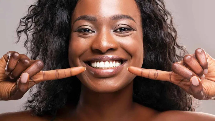 Smiling woman showing her white teeth after at-home whitening with GoBrushify toothbrush