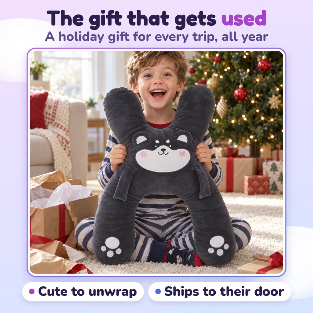 The gift that gets used: a boy unwrapping Niko the Husky by the holiday tree