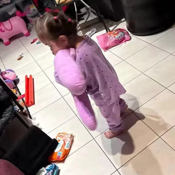 A toddler carrying her Nina the Bunny at home, a customer photo