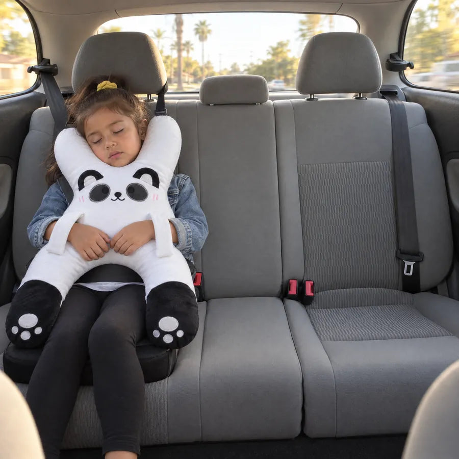 A girl asleep in a booster with Bao the Panda